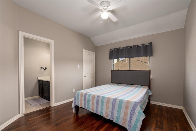 bedroom with lofted ceiling, ensuite bathroom, wood finished floors, and baseboards