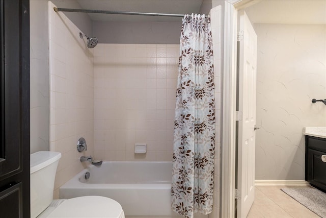 bathroom featuring baseboards, toilet, tile patterned floors, shower / bath combo with shower curtain, and vanity