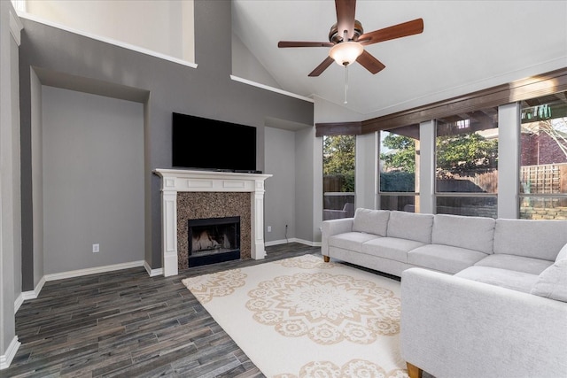 living area with ceiling fan, a fireplace, baseboards, and dark wood finished floors