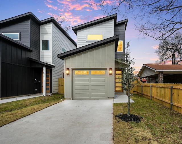 view of front facade with a garage and a lawn