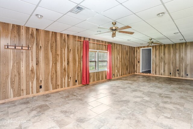 164 Ruth, Haughton, LA 71037 - unfurnished room featuring ceiling fan, wooden walls, and a drop ceiling