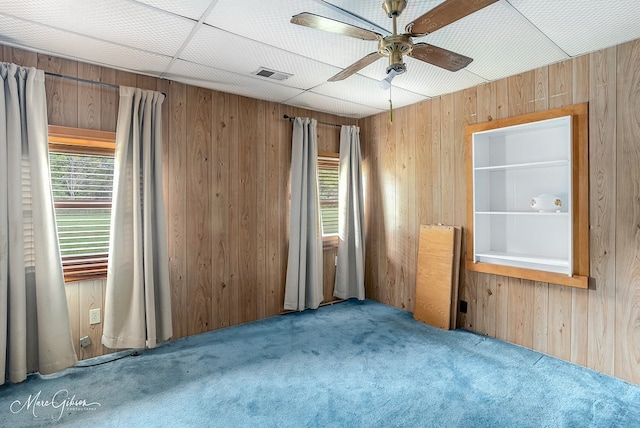 164 Ruth, Haughton, LA 71037 - carpeted empty room with wooden walls and ceiling fan