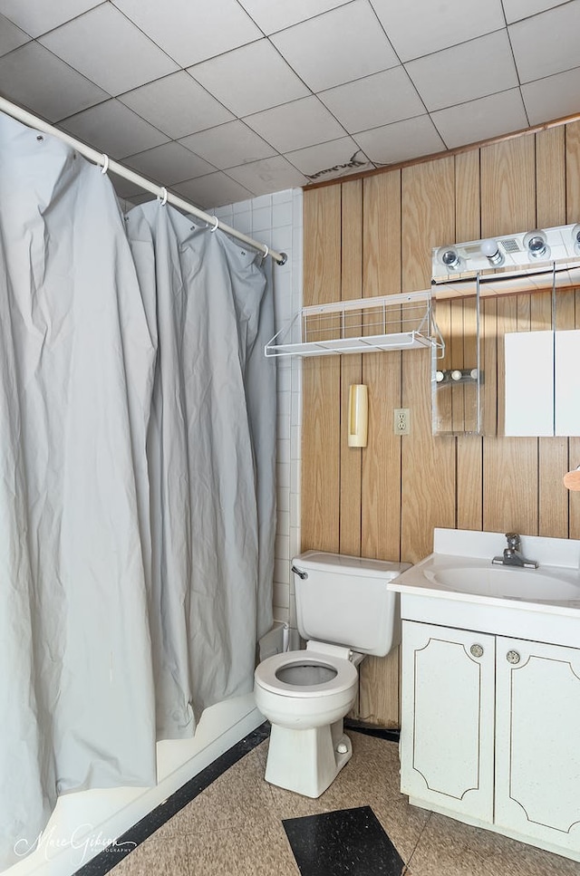 164 Ruth, Haughton, LA 71037 - full bathroom with a drop ceiling, vanity, toilet, and wood walls