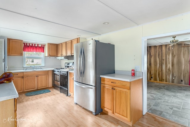 164 Ruth, Haughton, LA 71037 - kitchen featuring wood walls, gas range oven, stainless steel refrigerator, and light wood-type flooring