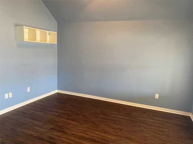 empty room featuring vaulted ceiling and hardwood / wood-style floors