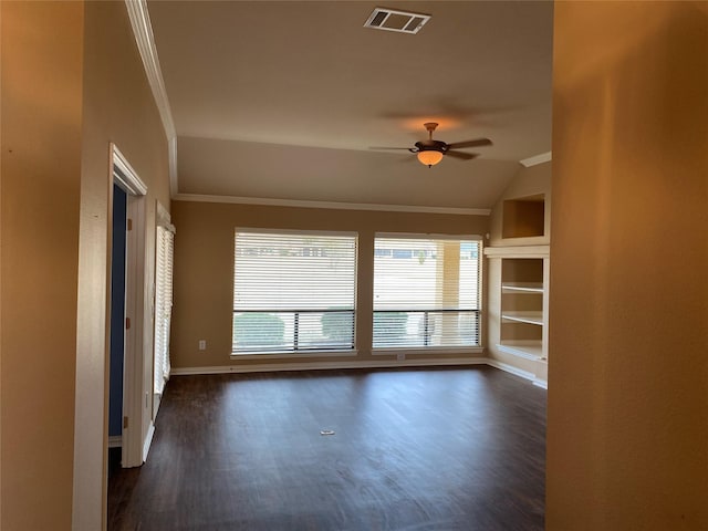 spare room with ceiling fan, lofted ceiling, crown molding, and dark hardwood / wood-style flooring