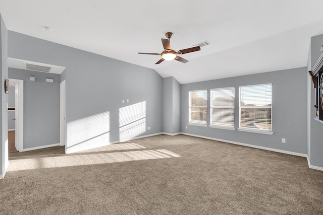 spare room featuring vaulted ceiling, ceiling fan, and carpet