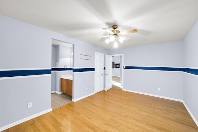 spare room with light hardwood / wood-style floors and ceiling fan