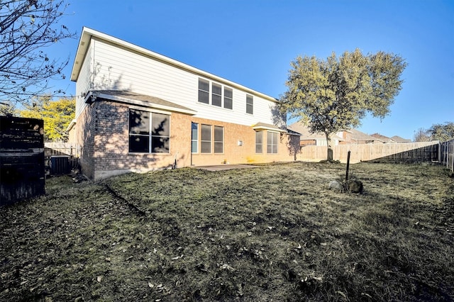 back of property featuring a patio, a yard, and central AC