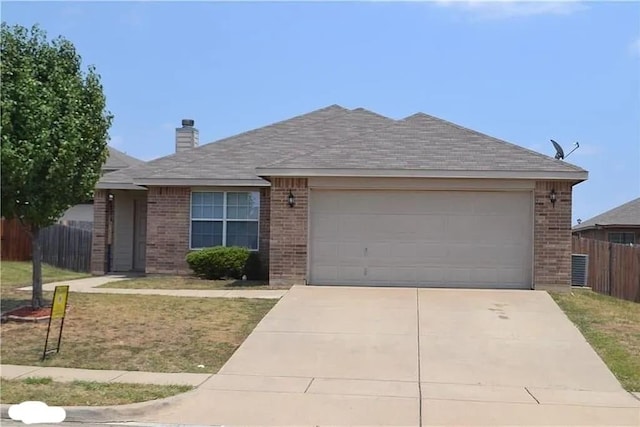 ranch-style home featuring a garage and a front lawn