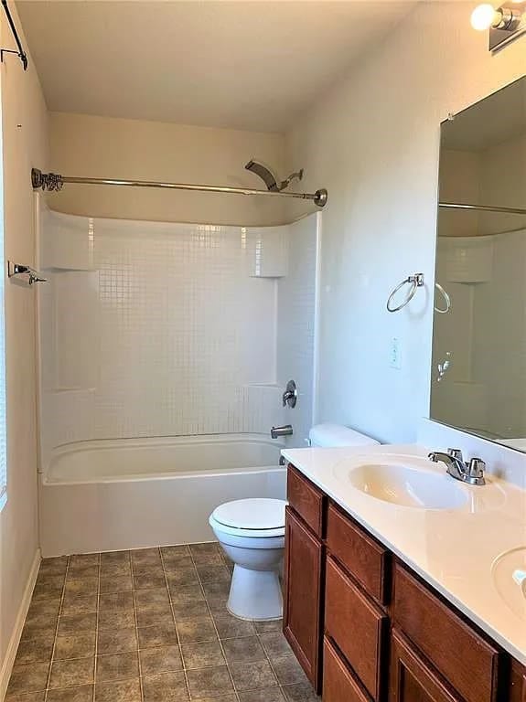 full bathroom featuring shower / bathtub combination, vanity, toilet, and tile patterned floors