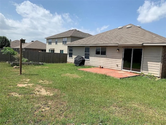 back of house featuring a patio and a yard