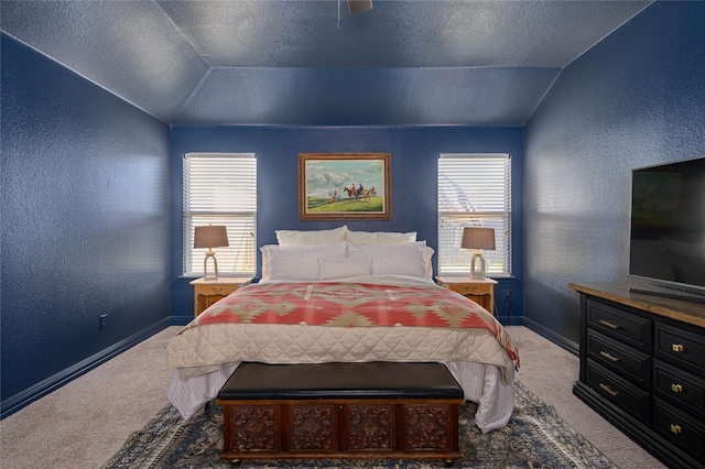 bedroom with vaulted ceiling, carpet flooring, and a textured ceiling