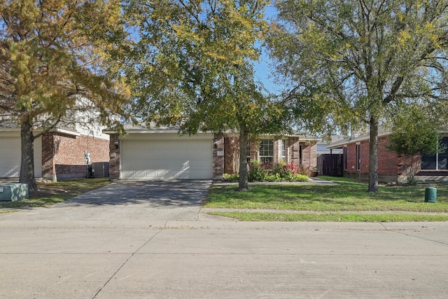 view of front of house featuring a garage, central AC unit, and a front lawn