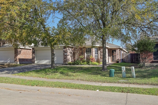 ranch-style home featuring a garage and a front lawn