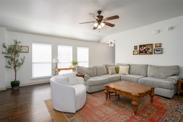 living room featuring dark wood-type flooring, ceiling fan, lofted ceiling, and a wealth of natural light