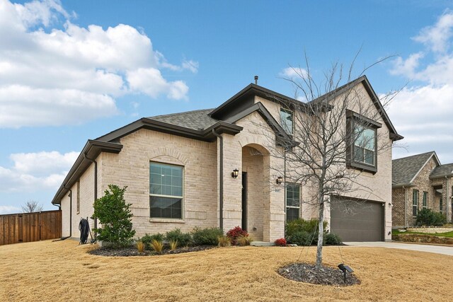 view of front of house featuring a garage and a front yard