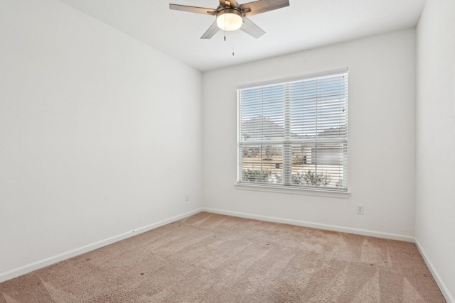 spare room featuring ceiling fan and light colored carpet