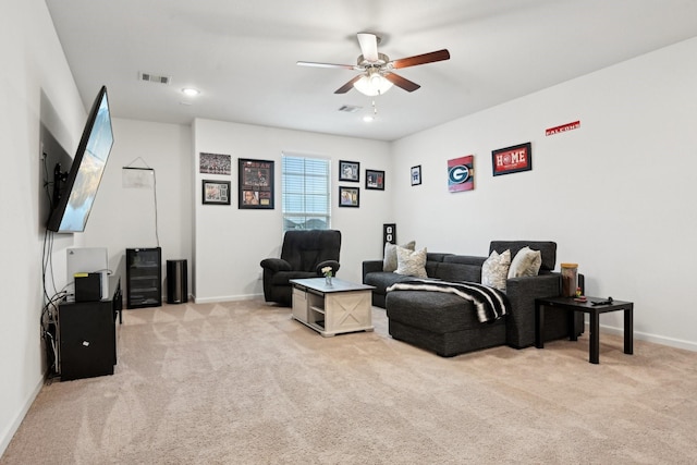 carpeted living room with ceiling fan