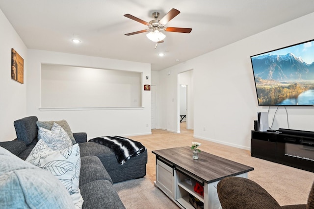 carpeted living room featuring ceiling fan