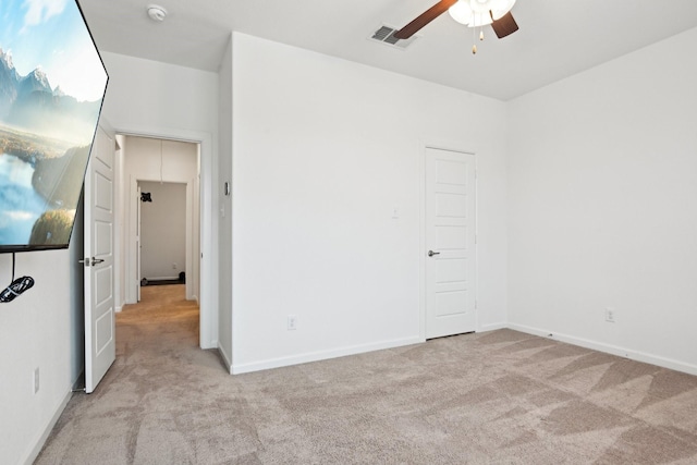 carpeted spare room with ceiling fan