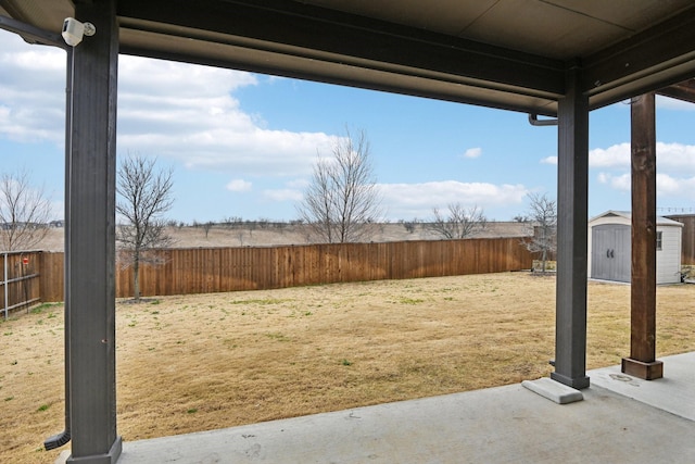 view of yard with a shed and a patio area