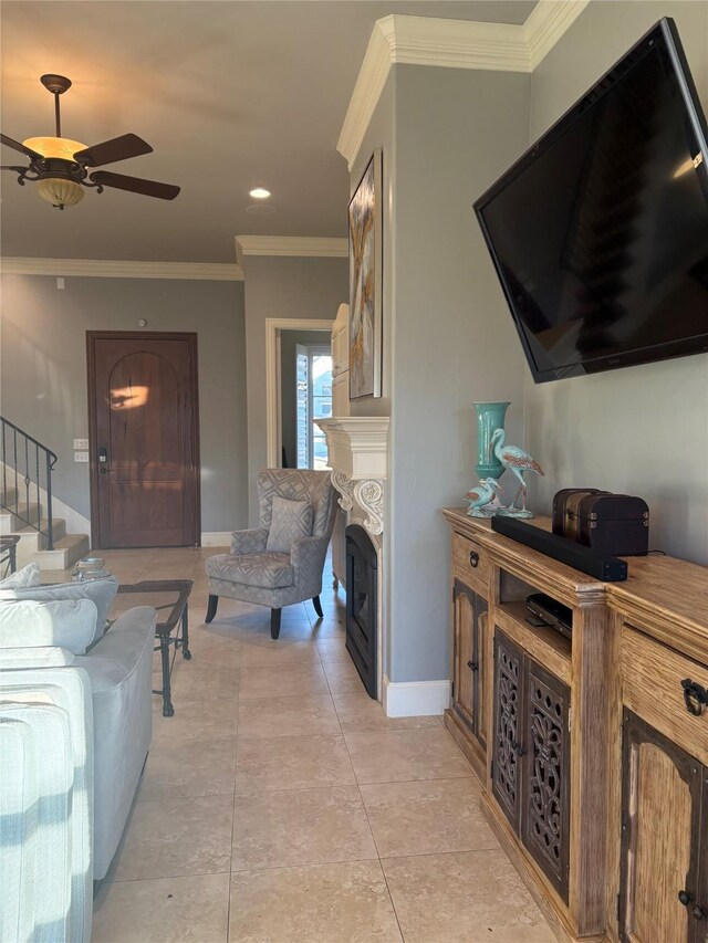 living room with ornamental molding, stairway, a fireplace, light tile patterned floors, and baseboards