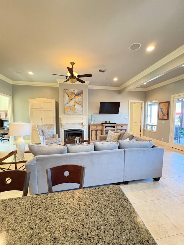 living room featuring a ceiling fan, light tile patterned flooring, a fireplace, recessed lighting, and ornamental molding