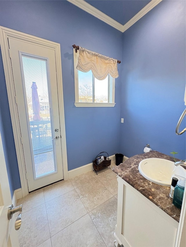 bathroom featuring baseboards, vanity, crown molding, and tile patterned flooring