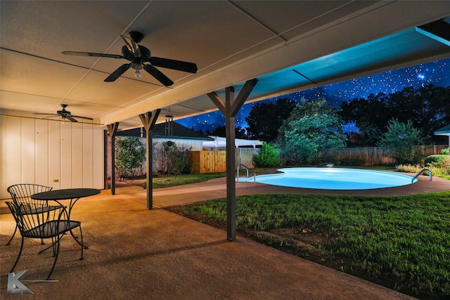 view of patio featuring a fenced in pool and ceiling fan