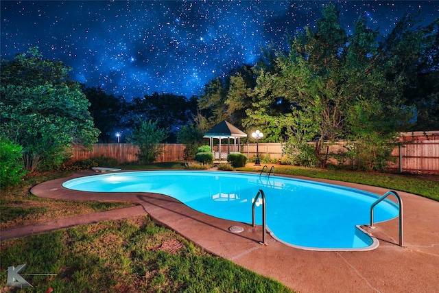 view of pool with a gazebo, a diving board, and a patio area