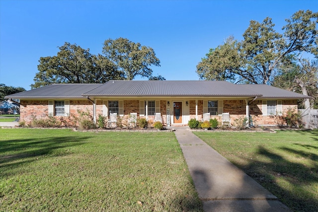 single story home with a front yard and covered porch