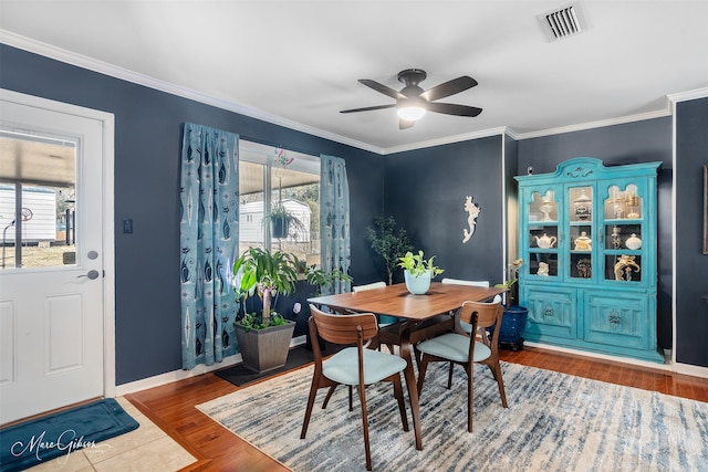 dining area with crown molding, ceiling fan, and hardwood / wood-style flooring