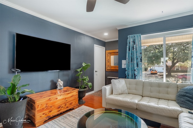 living room with crown molding, wood-type flooring, and ceiling fan