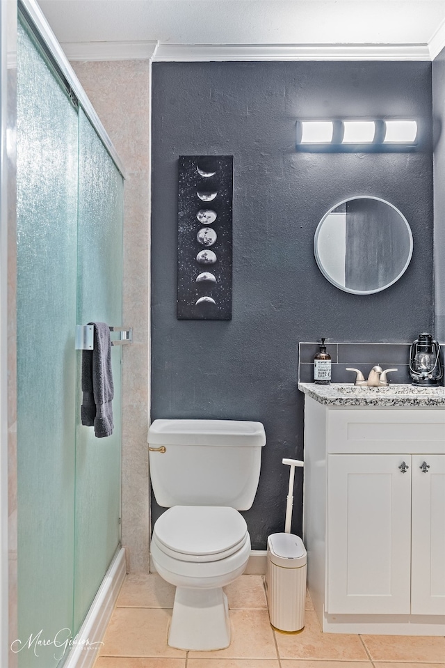 bathroom featuring vanity, a shower with door, ornamental molding, and tile patterned floors