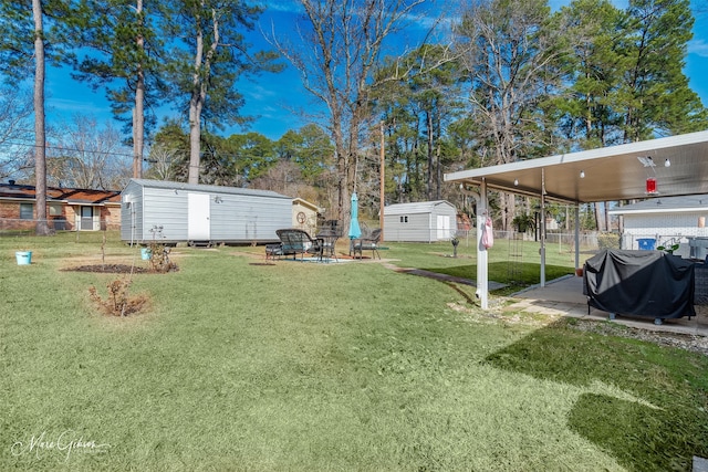 view of yard with a shed and a patio area