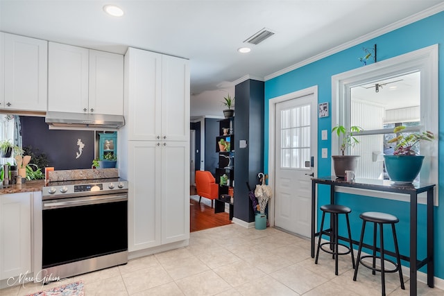 kitchen featuring white cabinetry, stainless steel electric stove, light tile patterned floors, and crown molding