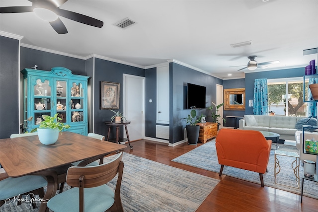 living room with crown molding and wood-type flooring