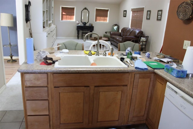 kitchen with sink, dishwasher, and light tile patterned flooring