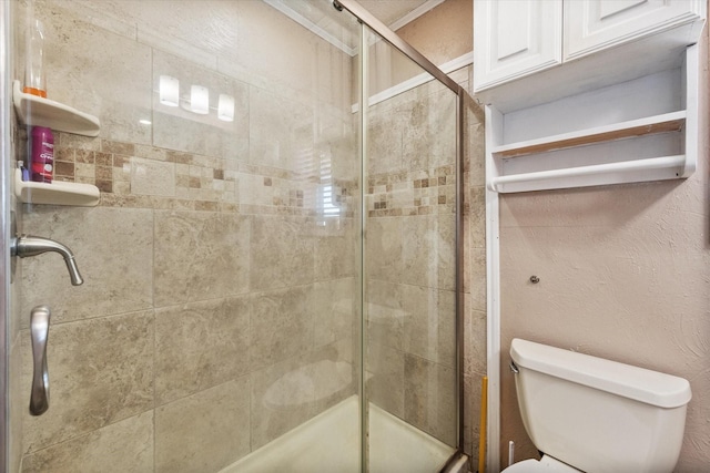 bathroom featuring an enclosed shower and toilet