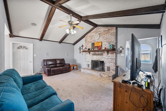 living room featuring vaulted ceiling with beams, a textured ceiling, carpet floors, ceiling fan, and a fireplace