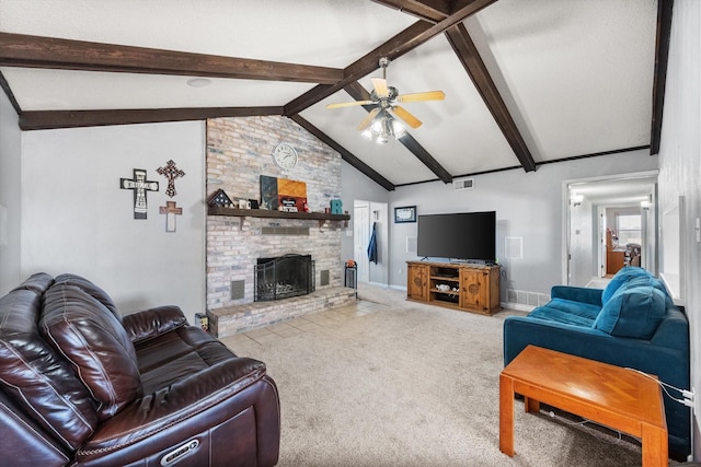 carpeted living room with ceiling fan, a fireplace, and vaulted ceiling with beams