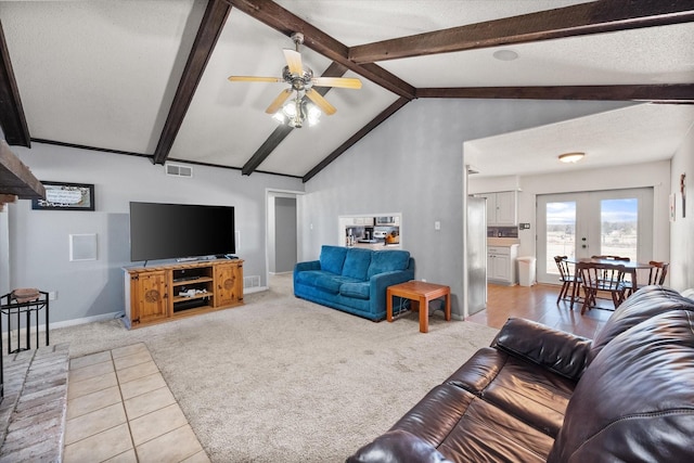 living room featuring vaulted ceiling with beams, light colored carpet, a textured ceiling, and french doors