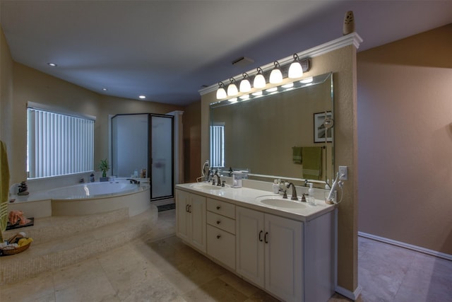 bathroom with vanity and a tub