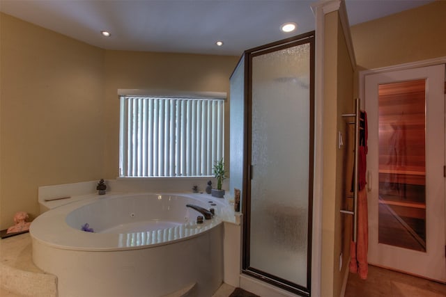 bathroom featuring tile patterned flooring and separate shower and tub