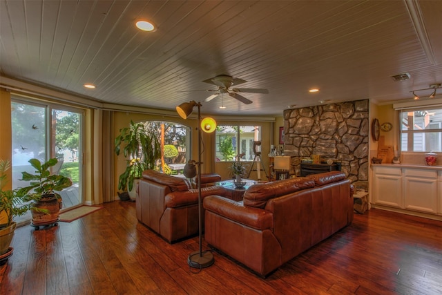 living room with dark hardwood / wood-style flooring, a fireplace, a wealth of natural light, and ceiling fan