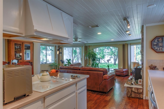 kitchen featuring crown molding, wooden ceiling, dark hardwood / wood-style floors, and white cabinets