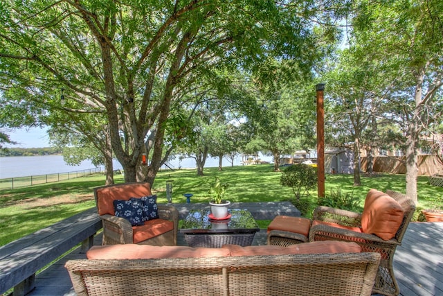 view of patio / terrace featuring a water view and a storage shed