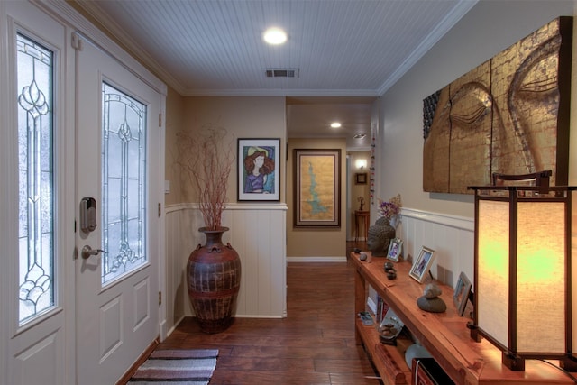 entrance foyer with dark hardwood / wood-style flooring and crown molding