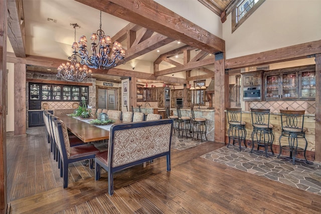 dining area featuring dark hardwood / wood-style floors, a high ceiling, and a notable chandelier